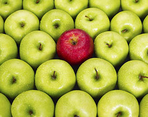 one red apple among many green apples
